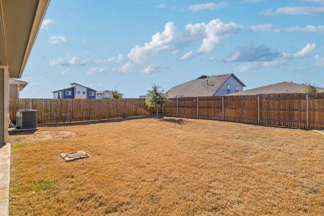 view of yard featuring central AC and a fenced backyard