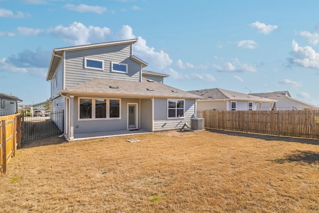 rear view of house featuring a fenced backyard, central AC unit, and a lawn