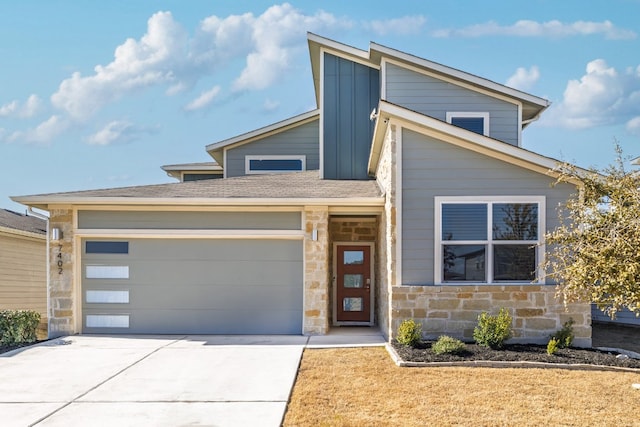 view of front facade featuring driveway, a garage, stone siding, roof with shingles, and board and batten siding