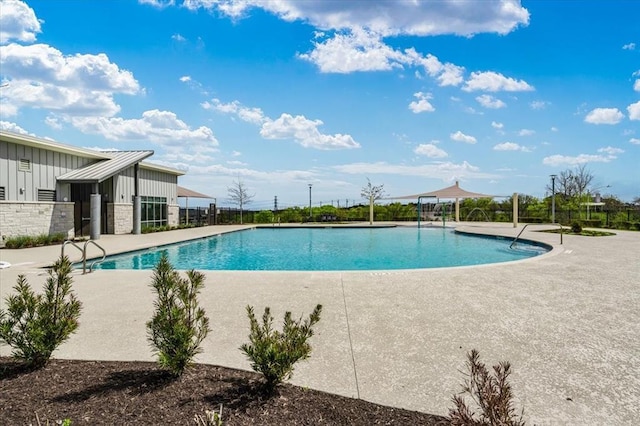 pool with fence and a patio