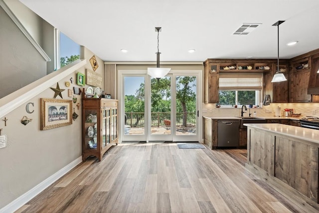 kitchen featuring light wood finished floors, visible vents, light countertops, and dishwasher