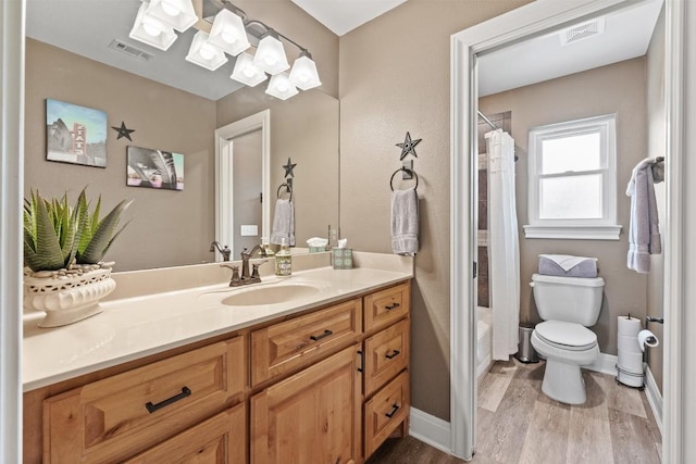 full bathroom with a shower with curtain, visible vents, vanity, and wood finished floors