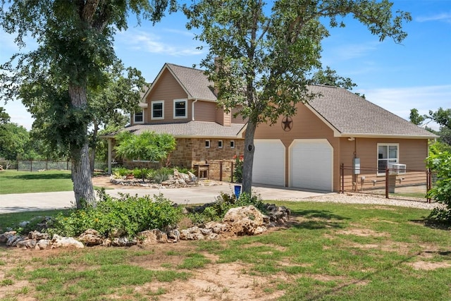 view of front of property featuring an attached garage, concrete driveway, a front yard, and fence