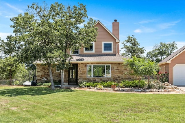 view of front of property with a garage, stone siding, a chimney, and a front yard