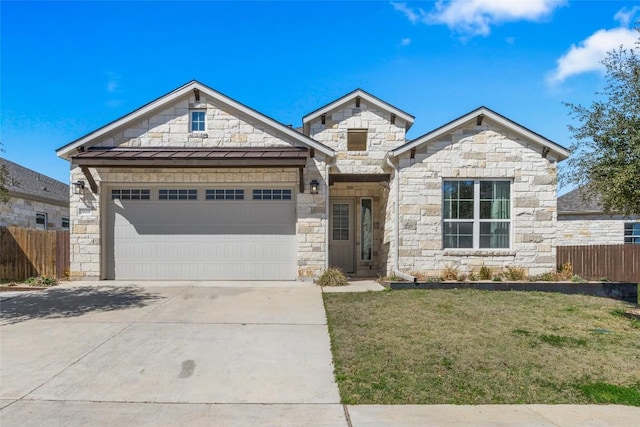 view of front of home featuring metal roof, a standing seam roof, concrete driveway, and fence