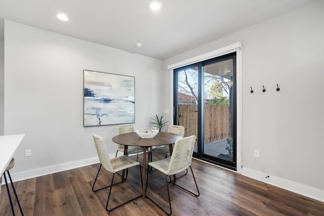 dining space featuring baseboards, wood finished floors, and recessed lighting