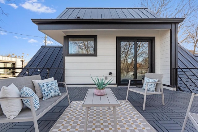 exterior space featuring an outdoor hangout area, metal roof, and a standing seam roof