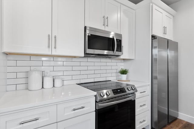 5403 Duval St Unit 2, Austin, TX 78751 - kitchen featuring appliances with stainless steel finishes, light countertops, white cabinets, tasteful backsplash, and dark wood finished floors