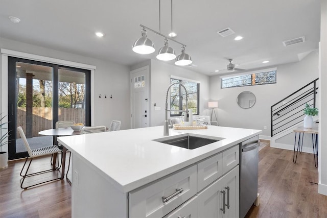 5403 Duval St Unit 2, Austin, TX 78751 - kitchen with dishwasher, a ceiling fan, light countertops, hanging light fixtures, and a center island with sink