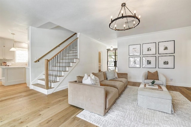 living area featuring light wood finished floors, stairway, a wealth of natural light, and crown molding