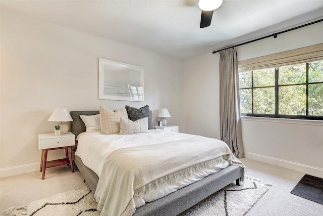 carpeted bedroom featuring baseboards and a ceiling fan