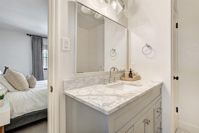 bathroom with vanity and baseboards