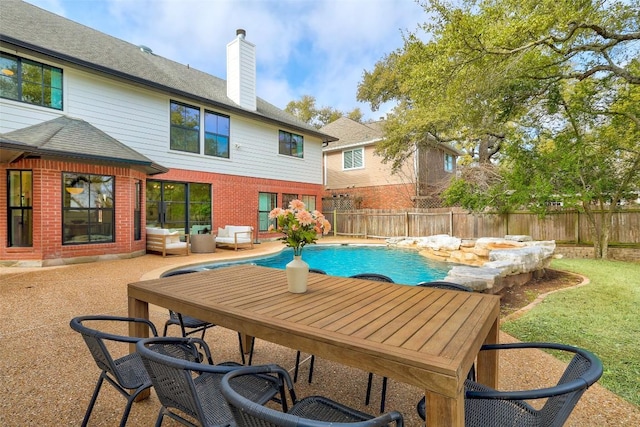 view of pool featuring a patio area, a fenced backyard, outdoor lounge area, and a fenced in pool