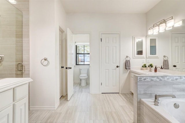 full bath featuring a relaxing tiled tub, a shower stall, toilet, and vanity