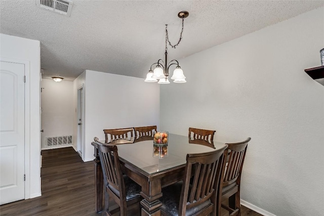 dining space with baseboards, a textured ceiling, visible vents, and dark wood-type flooring