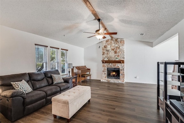 living area with visible vents, a ceiling fan, lofted ceiling with beams, dark wood-style flooring, and a fireplace