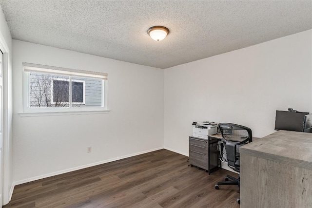 office area with dark wood-style floors, a textured ceiling, and baseboards