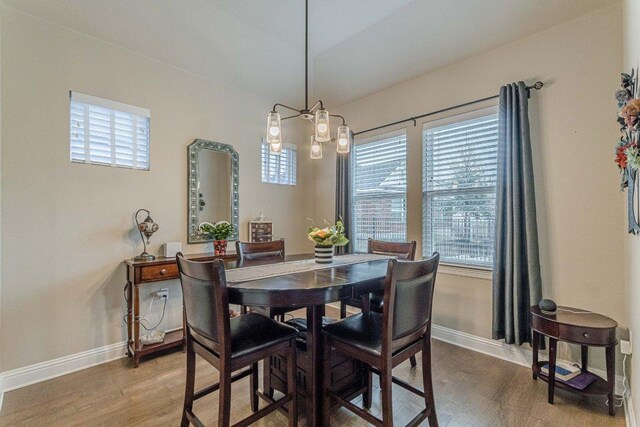 409 Flying Orchid Dr, San Marcos, TX 78666 - dining room featuring healthy amount of natural light, a chandelier, and wood finished floors
