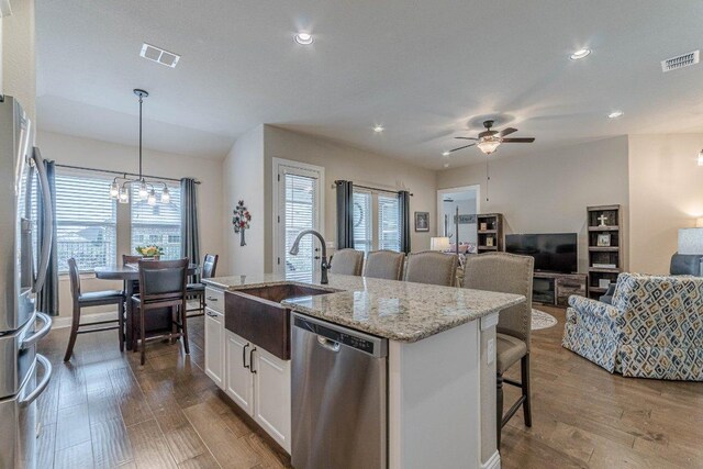 409 Flying Orchid Dr, San Marcos, TX 78666 - kitchen with stainless steel appliances, plenty of natural light, dark wood finished floors, and recessed lighting