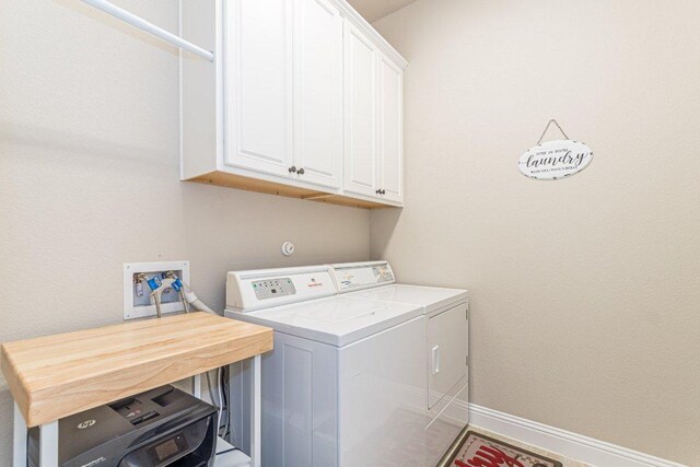 409 Flying Orchid Dr, San Marcos, TX 78666 - laundry area featuring washing machine and clothes dryer and cabinet space