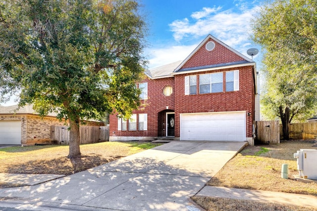 traditional-style house with a garage, fence, concrete driveway, and brick siding