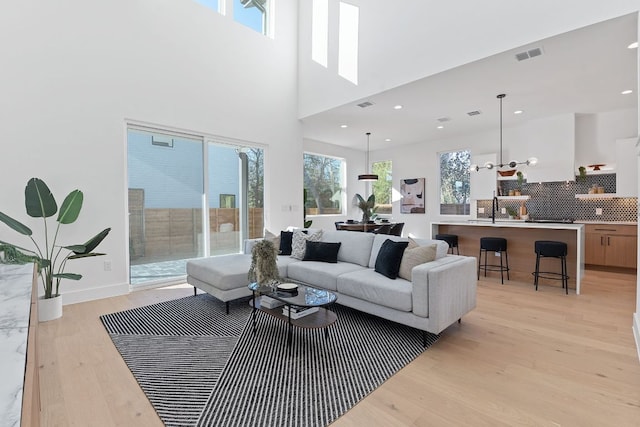 4402 Garnett St Unit 1, Austin, TX 78745 - living room with light wood-style floors and recessed lighting