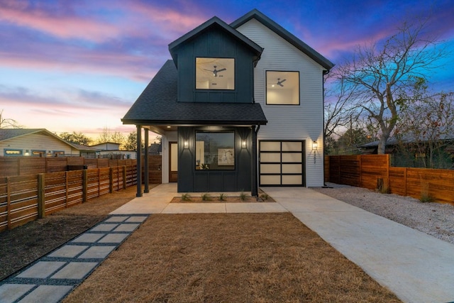 4402 Garnett St Unit 1, Austin, TX 78745 - view of front of home with board and batten siding, concrete driveway, a garage, roof with shingles, and covered porch