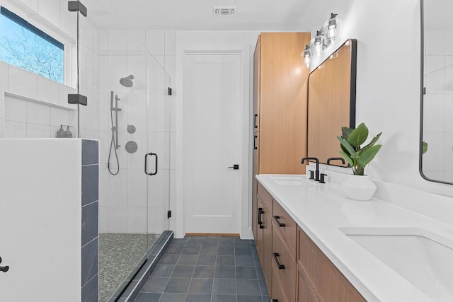 4402 Garnett St Unit 1, Austin, TX 78745 - full bathroom with a stall shower, double vanity, and tile patterned flooring