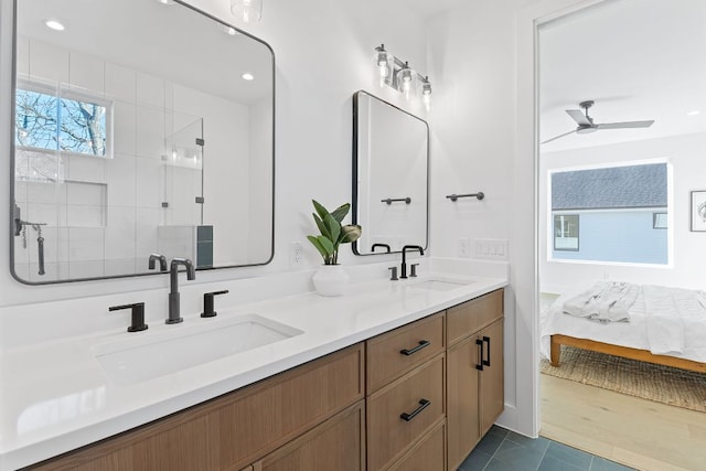 4402 Garnett St Unit 1, Austin, TX 78745 - ensuite bathroom featuring double vanity, a tile shower, ceiling fan, tile patterned flooring, and recessed lighting
