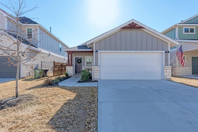 view of front of house with a garage, driveway, a shingled roof, fence, and board and batten siding