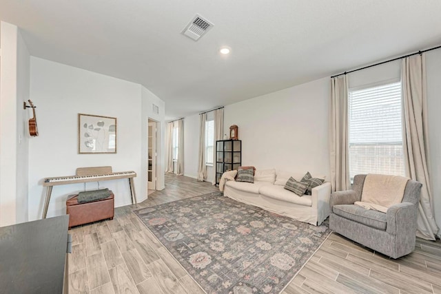 living area featuring wood finish floors, visible vents, and recessed lighting