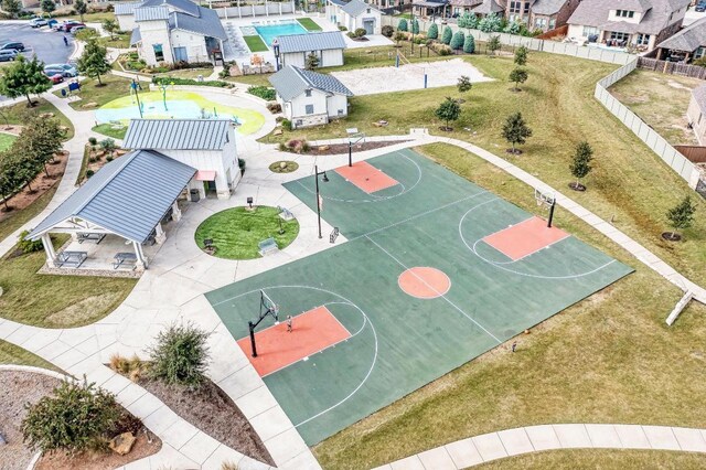 view of sport court with community basketball court, fence, and a residential view