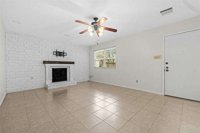 unfurnished living room with light tile patterned floors, a brick fireplace, visible vents, and a ceiling fan