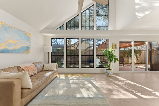 unfurnished living room featuring high vaulted ceiling and wood finished floors