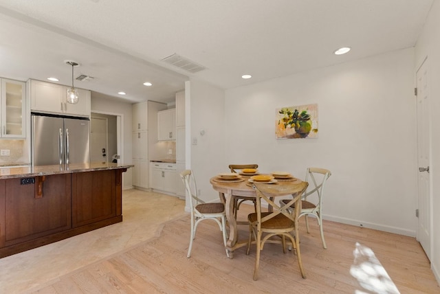 dining room with light wood-type flooring, baseboards, visible vents, and recessed lighting