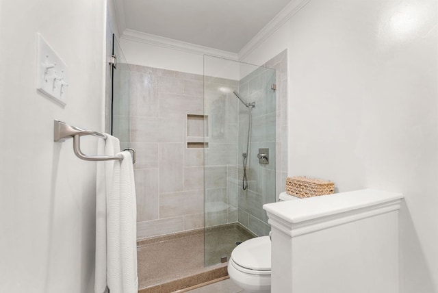 bathroom with ornamental molding, a stall shower, and toilet