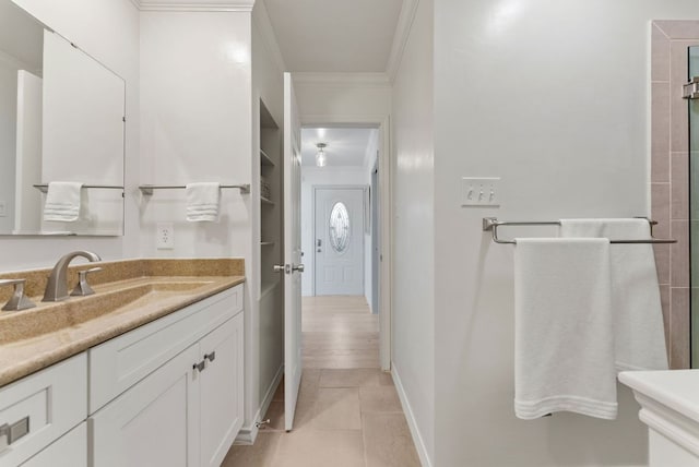 interior space featuring tile patterned flooring, ornamental molding, baseboards, and vanity