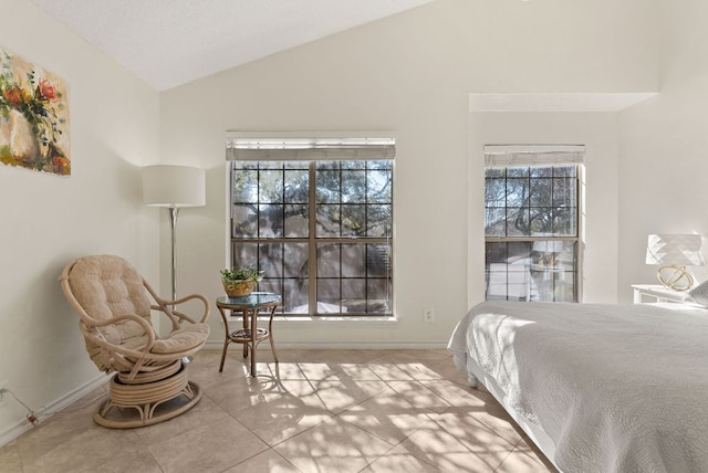 tiled bedroom featuring lofted ceiling, multiple windows, and baseboards