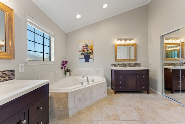 full bathroom with a garden tub, two vanities, ornamental molding, a sink, and tile patterned floors