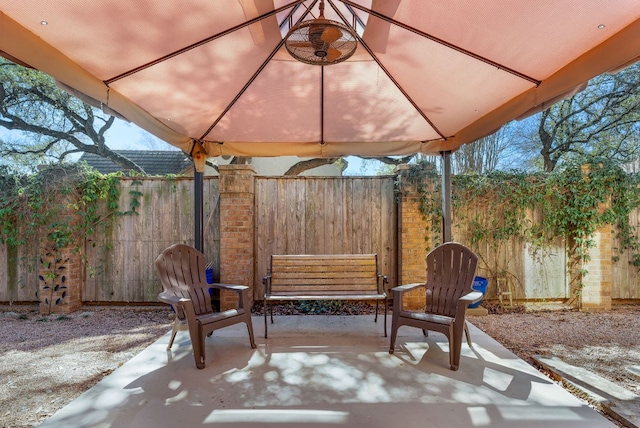 view of patio with fence and a gazebo