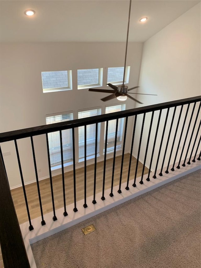 stairway with recessed lighting, wood finished floors, plenty of natural light, and ceiling fan