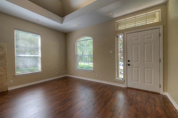 foyer featuring wood finished floors and baseboards