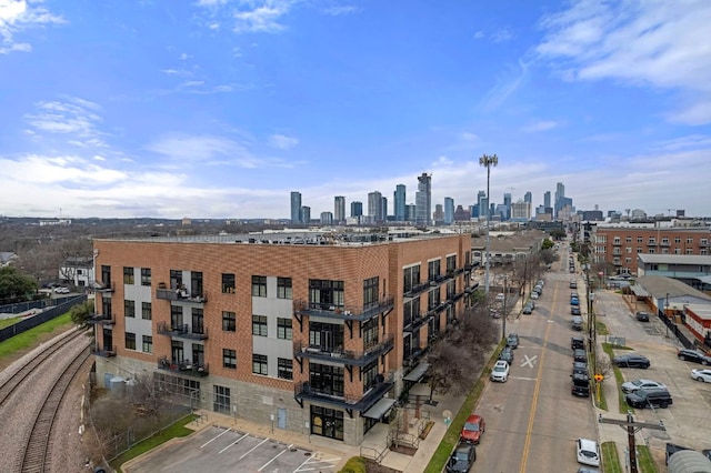 2235 E 6th St Unit 210, Austin, TX 78702 - view of building exterior featuring uncovered parking and a skyline view