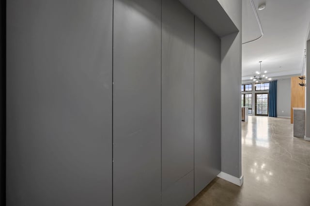 2235 E 6th St Unit 210, Austin, TX 78702 - hallway with a chandelier and baseboards