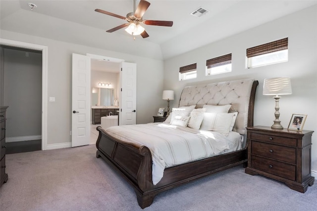 bedroom featuring visible vents, baseboards, ceiling fan, carpet, and ensuite bath