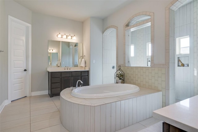 bathroom with vanity, tile patterned floors, and a garden tub