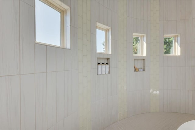 full bath featuring a tile shower