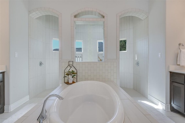 full bath with vanity, walk in shower, and a garden tub