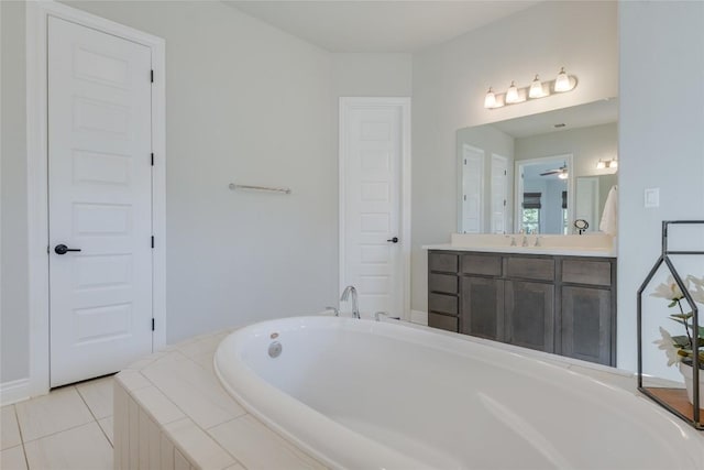 bathroom with vanity, a garden tub, and tile patterned floors
