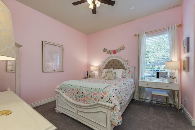 bedroom with dark colored carpet, a ceiling fan, and baseboards